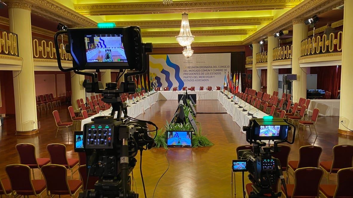 Dos cámaras de Estudio9 con monitor frente al salón preparado para la LXI reunión del Consejo del Mercado Común, con la mesa en U al fondo.